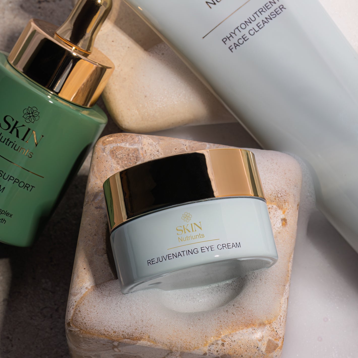 Skin Nutriunts products featuring a jar of 'Rejuvenating Eye Cream' on a stone surface.