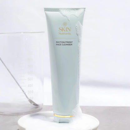 Tube of Skin Nutriunts Phytonutrient Face Cleanser on a white background with a beaker to the left side